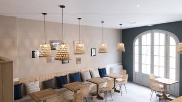 A modern interior with wooden tables and chairs, a bench with cushions, and pendant lights.