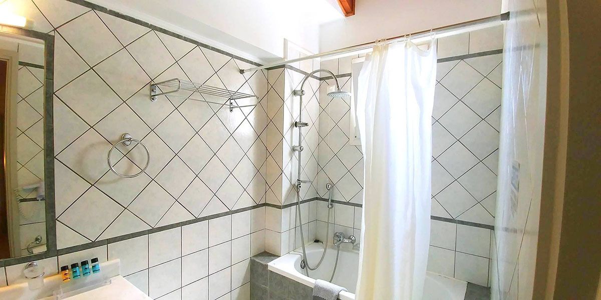 A modern bathroom with a shower, a bathtub, and a sink.