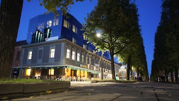 Experience the charm of Wiesbutt Hotel's classic architecture, set amidst a picturesque street lined with trees and outdoor seating.