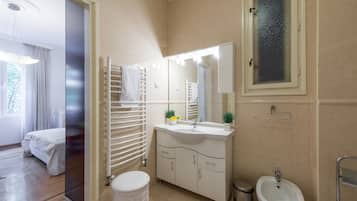 Shower, designer toiletries, hair dryer, slippers