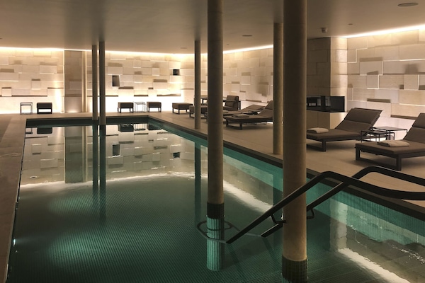 Indoor pool, open 8:00 AM to 8:00 PM, pool loungers