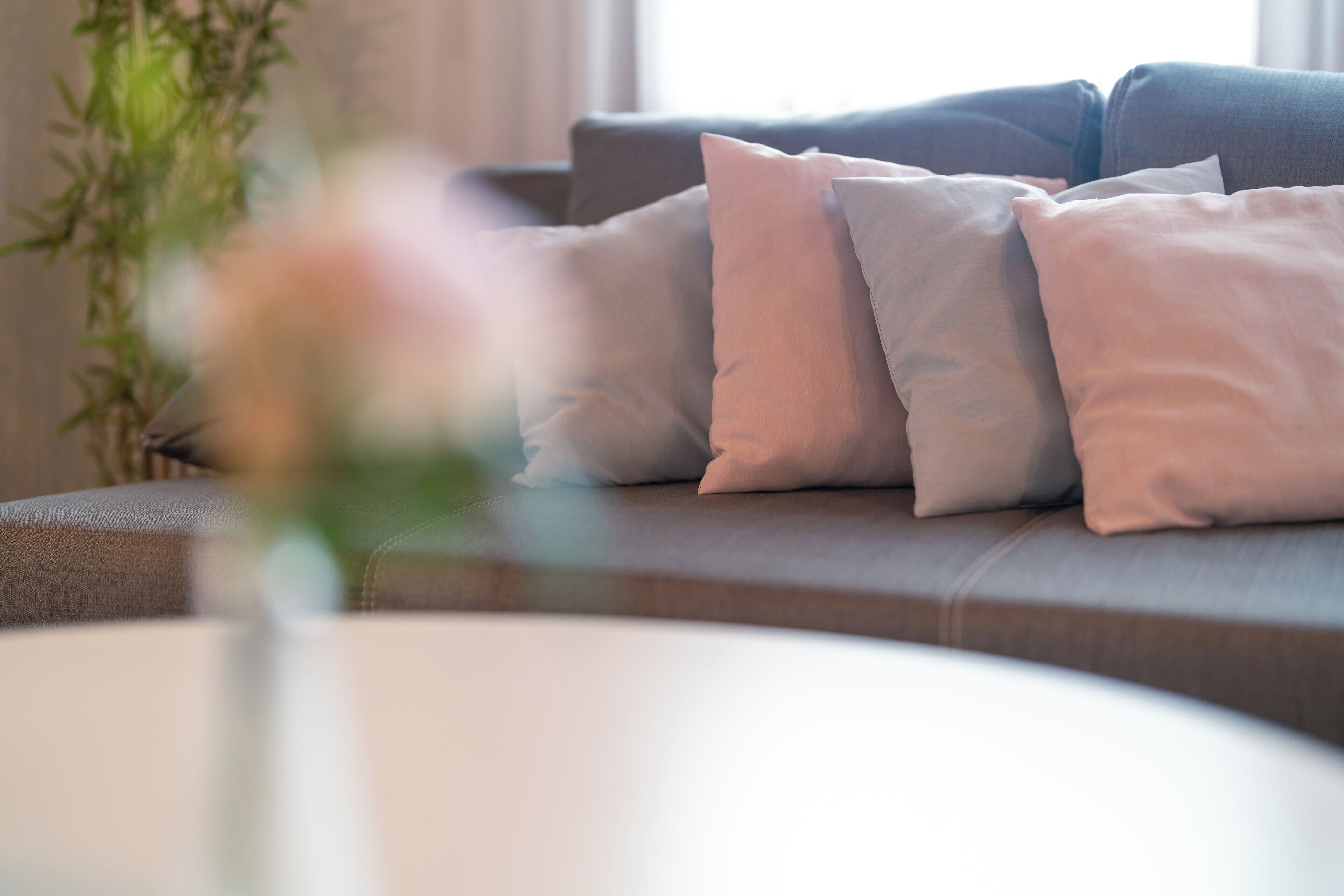 A modern living room with a sofa and cushions.