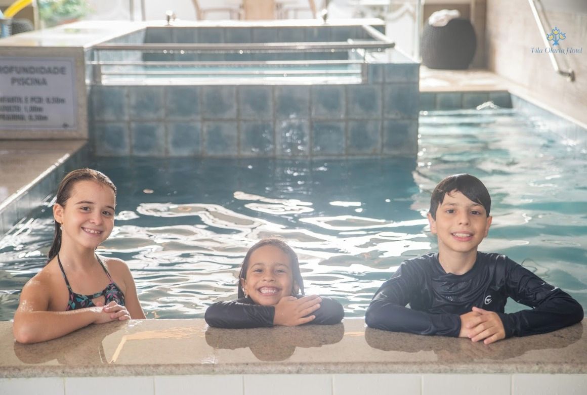 A swimming pool with three individuals.
