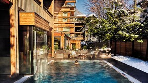 A wooden cabin with a hot tub and outdoor seating. - DasPosthotel – Boutique Hotel (Zell am Ziller)