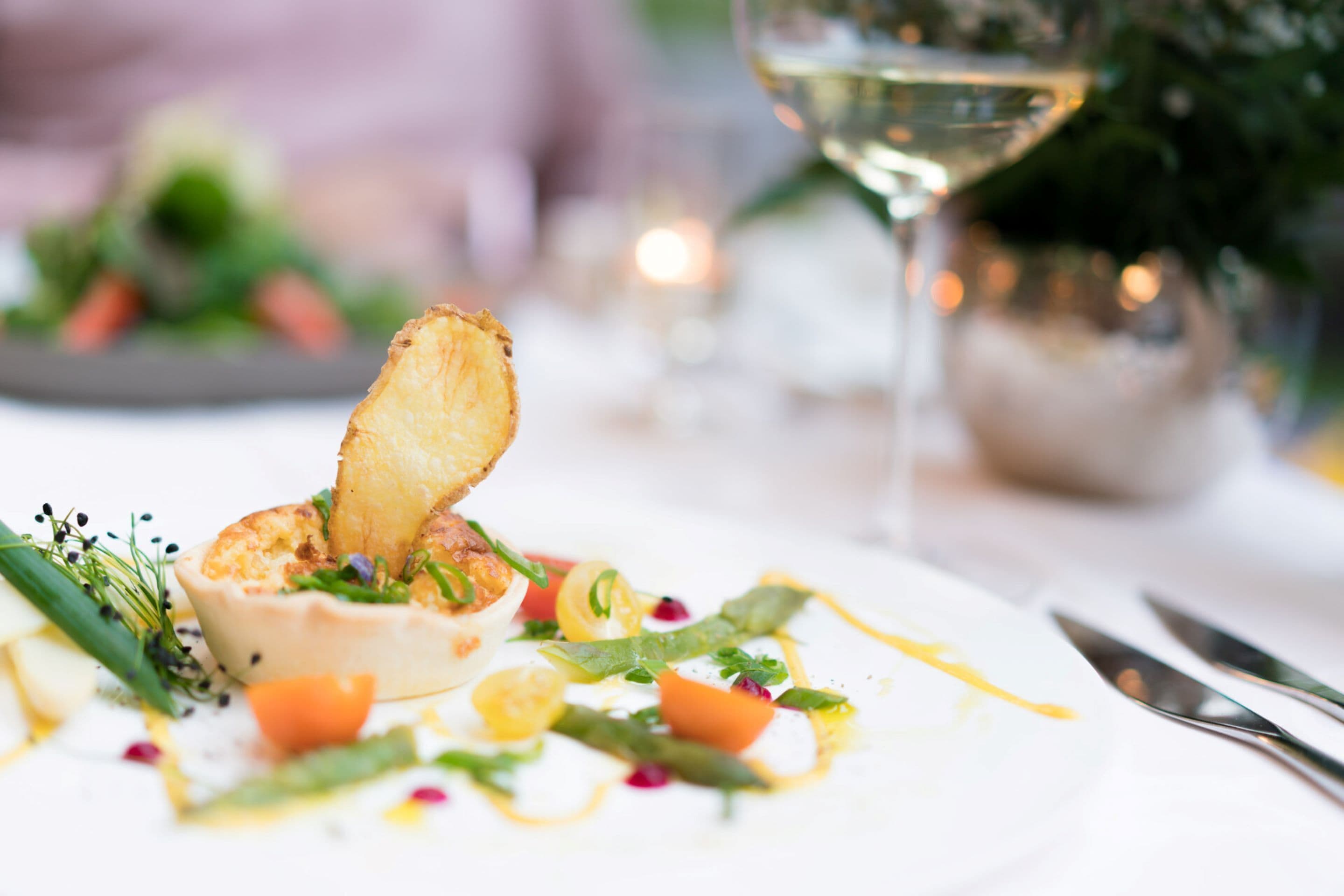 A plate of food with a variety of vegetables and a piece of bread.