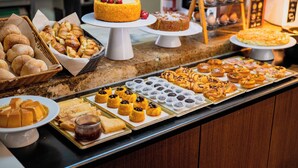 A buffet with various baked goods, including pastries, cakes, and bread. - Casa do Patio by Shiadu (Lisbon)
