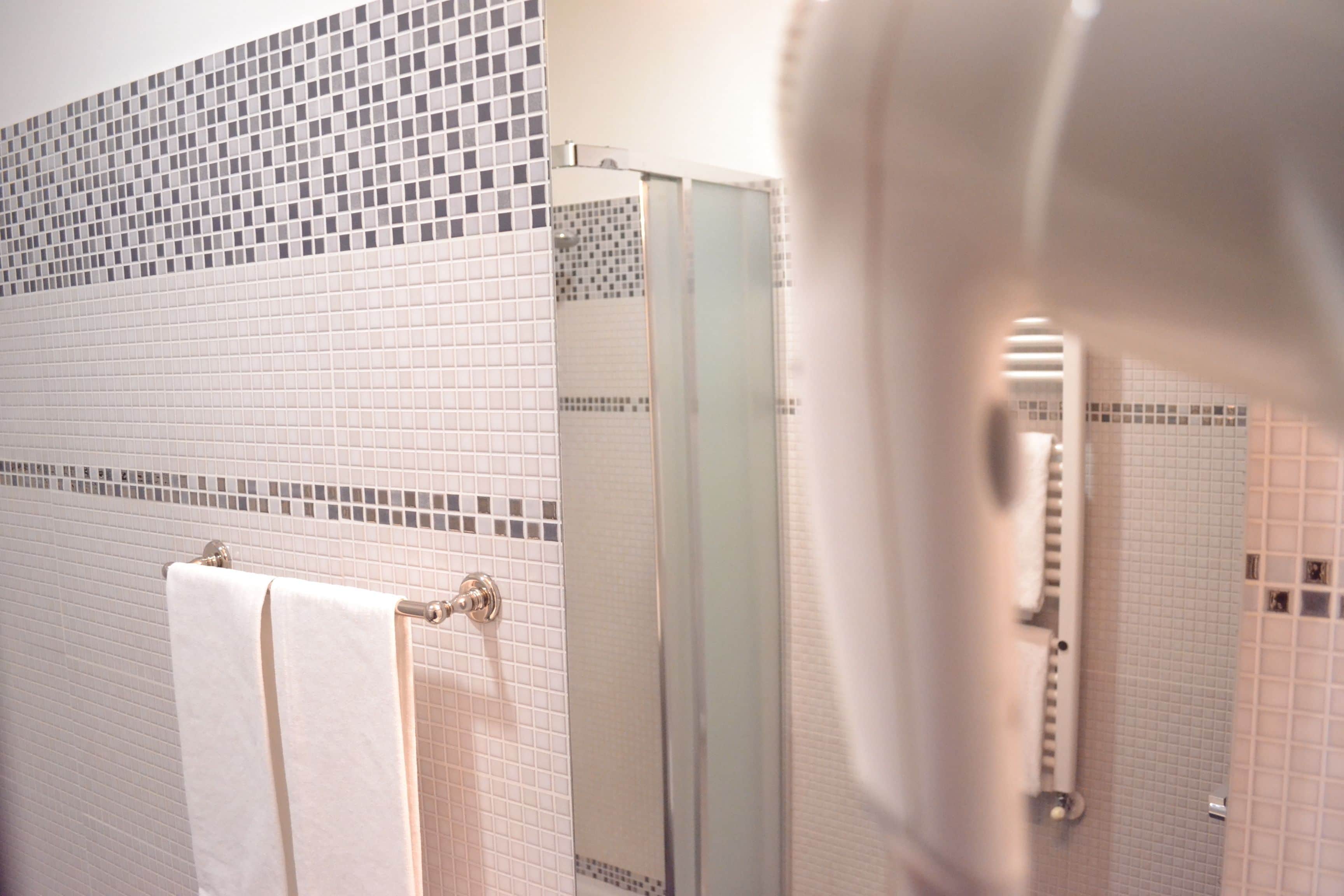 shower, rainfall showerhead, hair dryer, towels