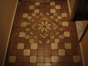 Ein Boden mit geometrischem Muster aus Fliesen.