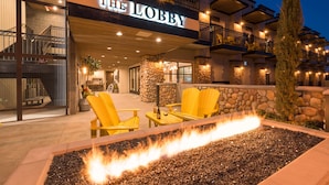 A building named "The Lobby" with outdoor seating and a fire feature.