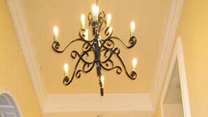 A hallway with a chandelier, arches, and a reflective floor. - Rafael Mansion Bangkok Airport (Bang Phli)