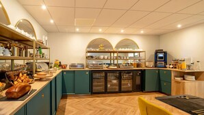 A modern kitchen with a buffet setup, including a variety of food items and a self-service station.