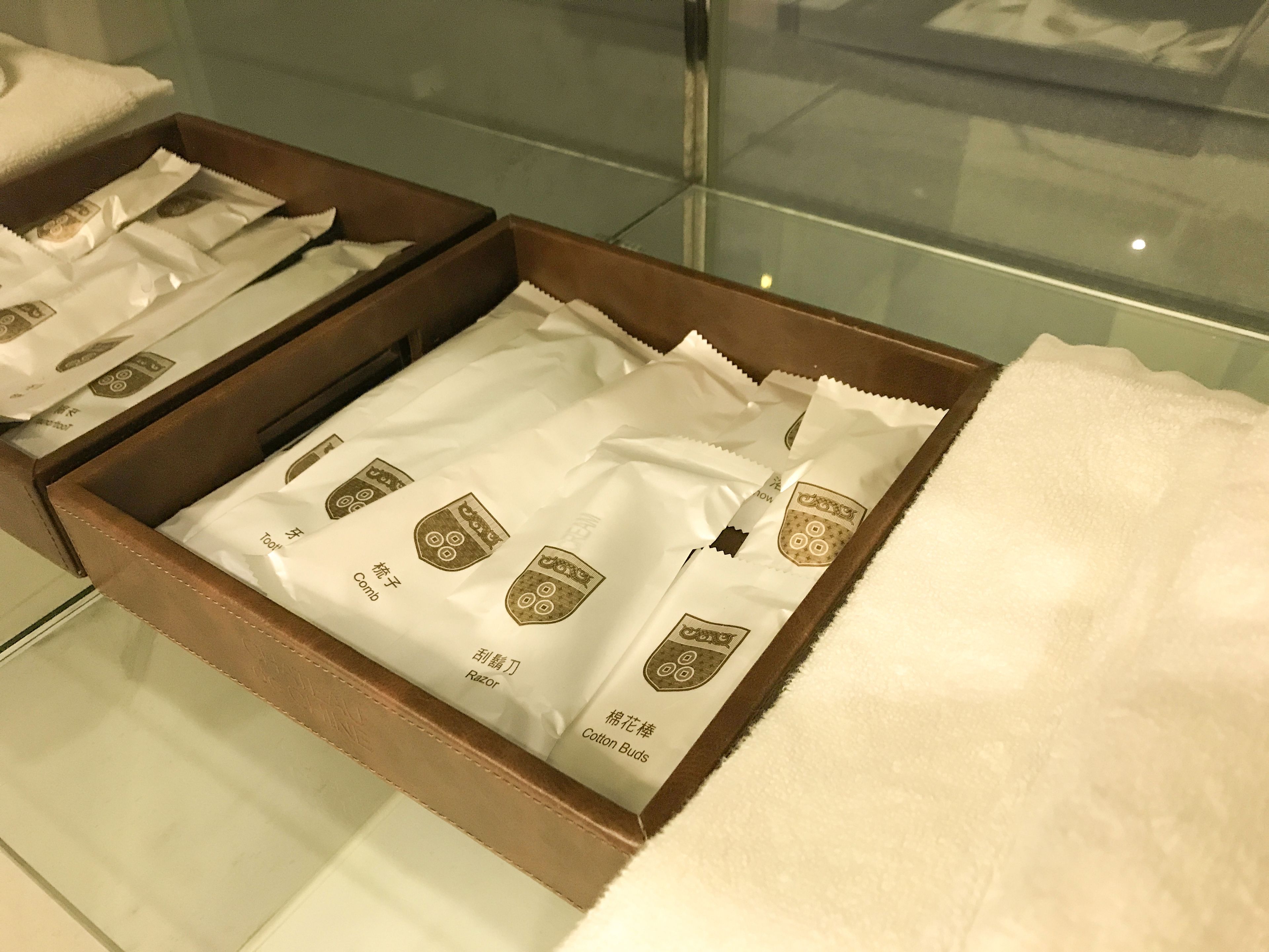 A wooden box with compartments containing various grooming products.