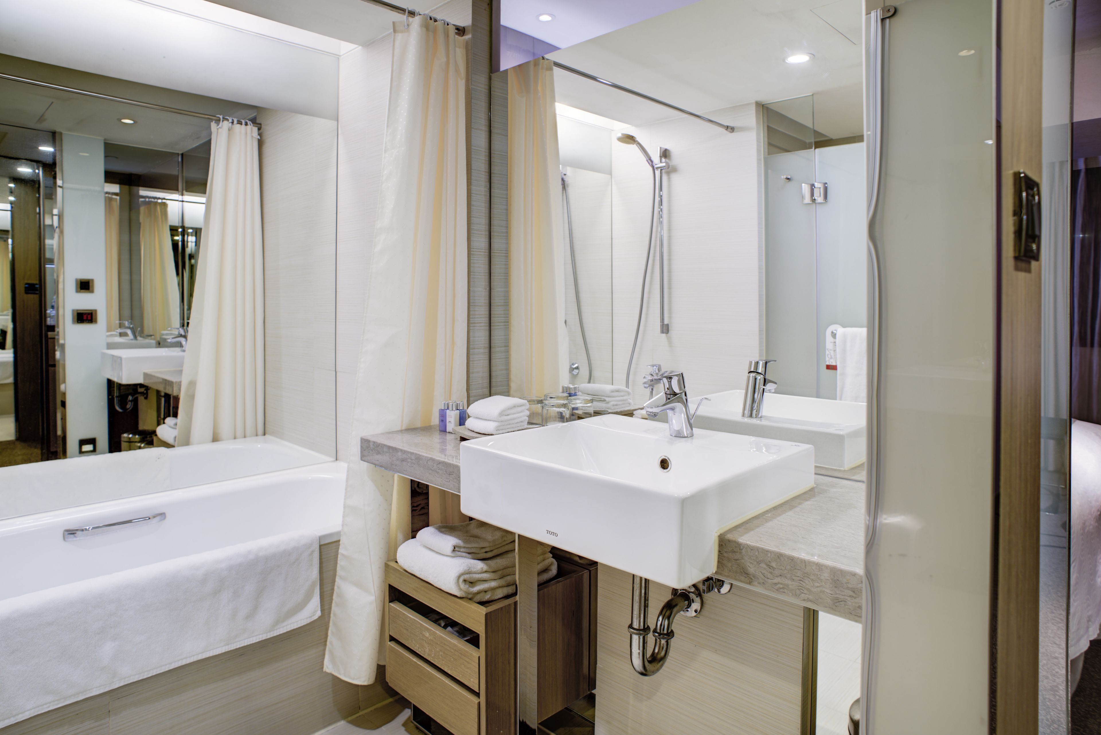 superior queen room | bathroom | shower, eco-friendly toiletries, hair dryer, bathrobes