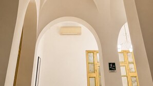 An interior with arched ceilings and a visible emergency exit sign. - Ca' Dei Polo (Venice)