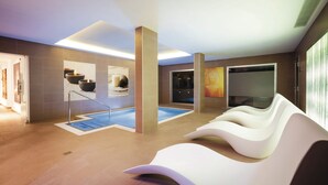 A modern spa with a pool, relaxation areas, and art on the walls. - Hotel Riu Arecas - Adults Only (Adeje)