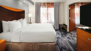 A hotel room with a large bed, a desk, a television, and a wardrobe. - Fairfield Inn & Suites by Marriott Denver Aurora / Parker (Aurora)