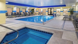 A hotel swimming pool with multiple lanes, lounge chairs, and a clear view of the outside. - Fairfield Inn & Suites by Marriott Denver Aurora / Parker (Aurora)
