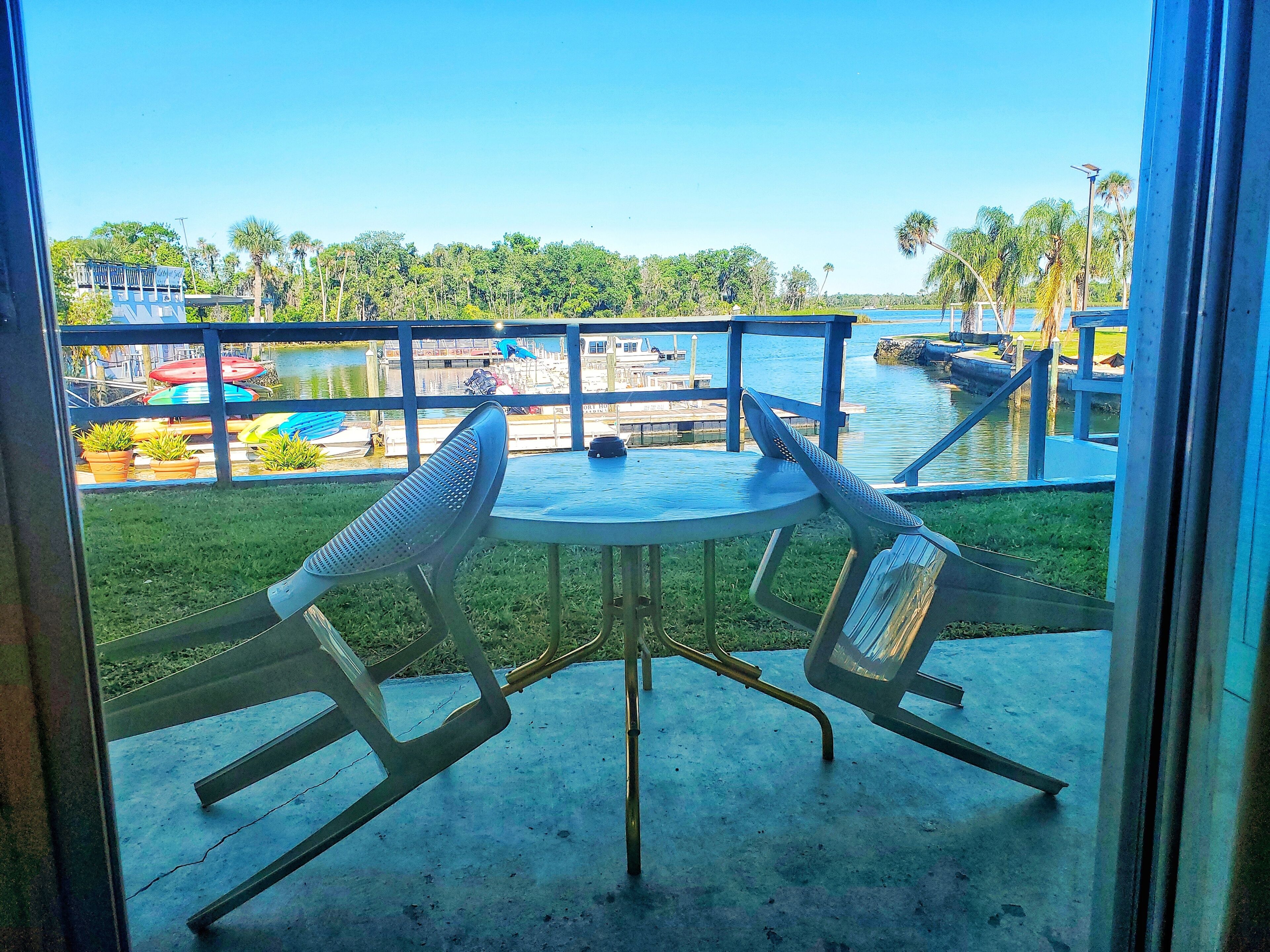 A balcony with a table and chairs overlooking a water park.
