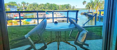 A balcony with a table and chairs overlooking a water park.