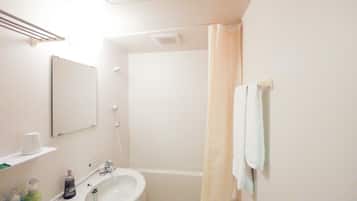 A bathroom with a sink, mirror, shower curtain, and towel rack.