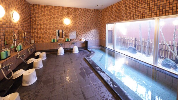 A public bath area with multiple toilets, a large window, and a tiled floor. - Hotel Route-Inn Omaezaki (Omaezaki)