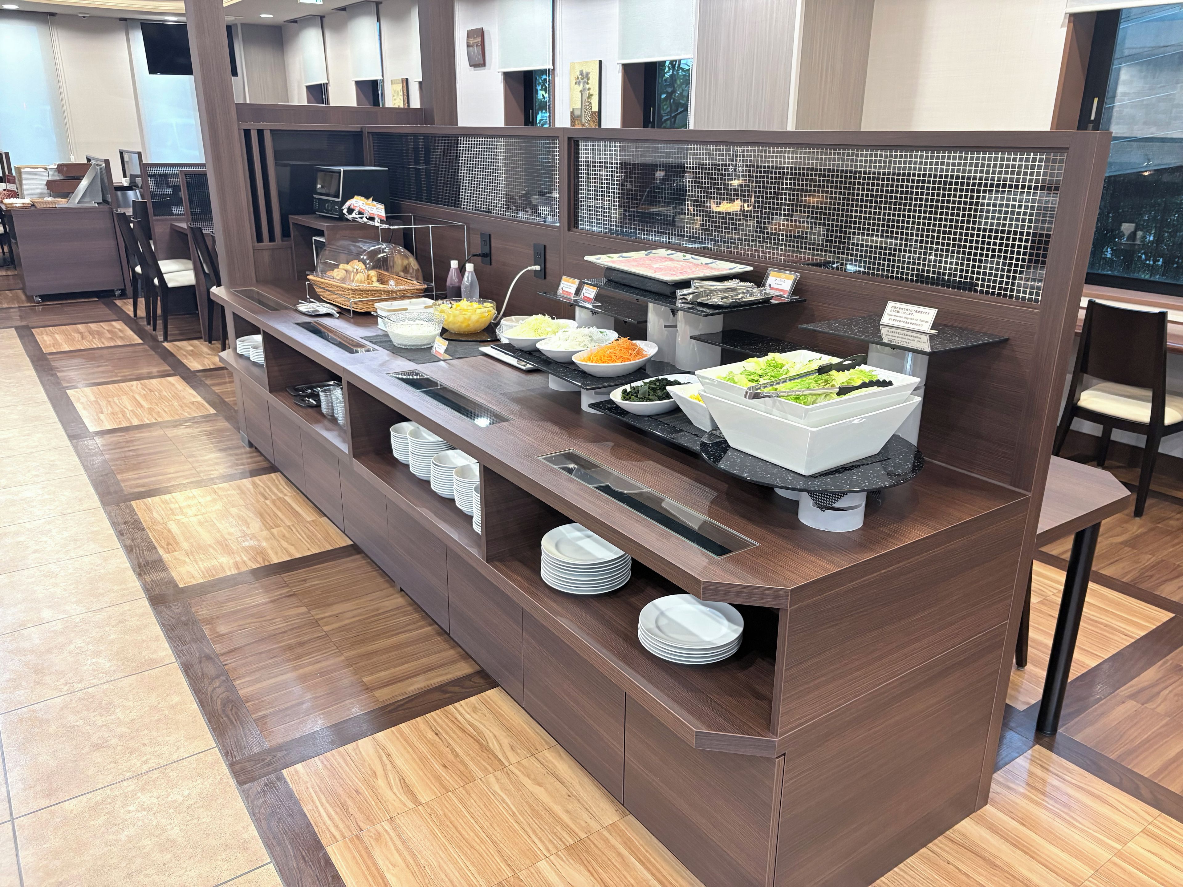 A buffet setup with various food items and utensils.