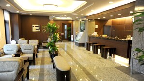 A hotel lobby with seating areas, a reception desk, and a reception counter. - Hotel Route - Inn Ena (Ena)