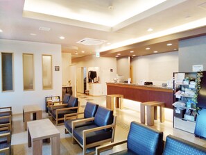 A hotel lobby with seating, a reception desk, and a staircase leading to another floor. - Hotel Route-Inn Oogaki Inter (Ogaki)