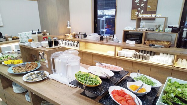 A buffet setup with various food items and condiments. - Hotel Route-Inn Oogaki Inter (Ogaki)