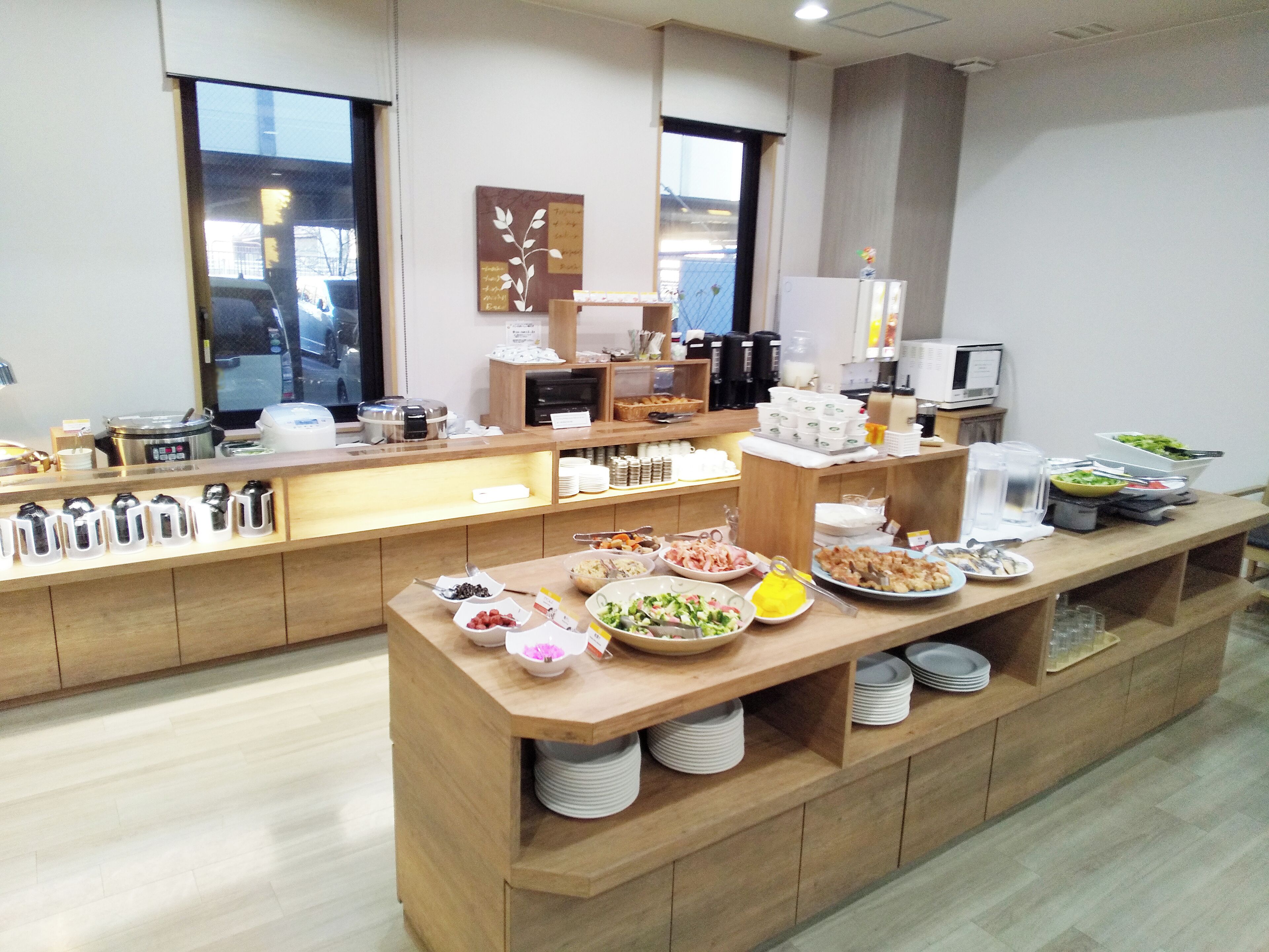 A buffet setup with various food items and condiments.