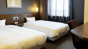A hotel room with two beds, a desk, a nightstand, a wall clock, a painting, and a window with curtains. - Hotel Route-Inn Seki (Seki)