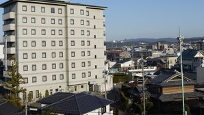 A multi-story hotel with a uniform facade, numerous windows, and a sign indicating it is a hotel. - Hotel Route Inn Tajimi Inter (Tajimi)