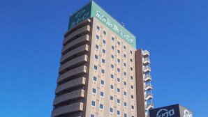 A high-rise hotel with multiple floors, balconies, and a prominent sign at the top. - Hotel Route Inn Toki (Toki)