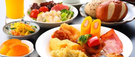 A breakfast spread with various dishes including eggs, bacon, and vegetables.