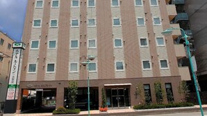 A multi-story hotel with a prominent sign at the top.