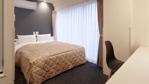 A hotel room with a bed, a desk, and a window with curtains. - Hotel New Touhoku (Tokyo)