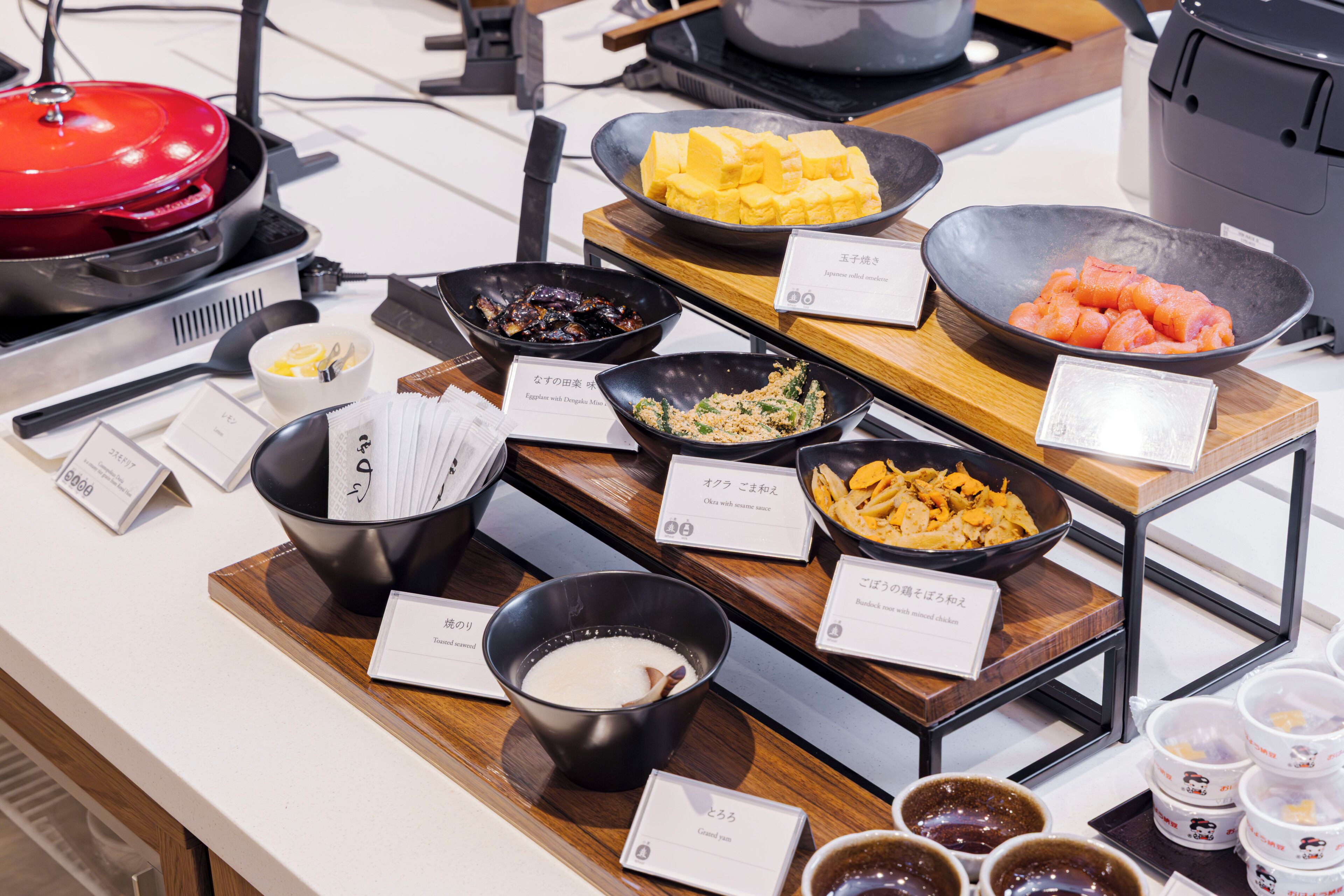 A buffet with various dishes and condiments.
