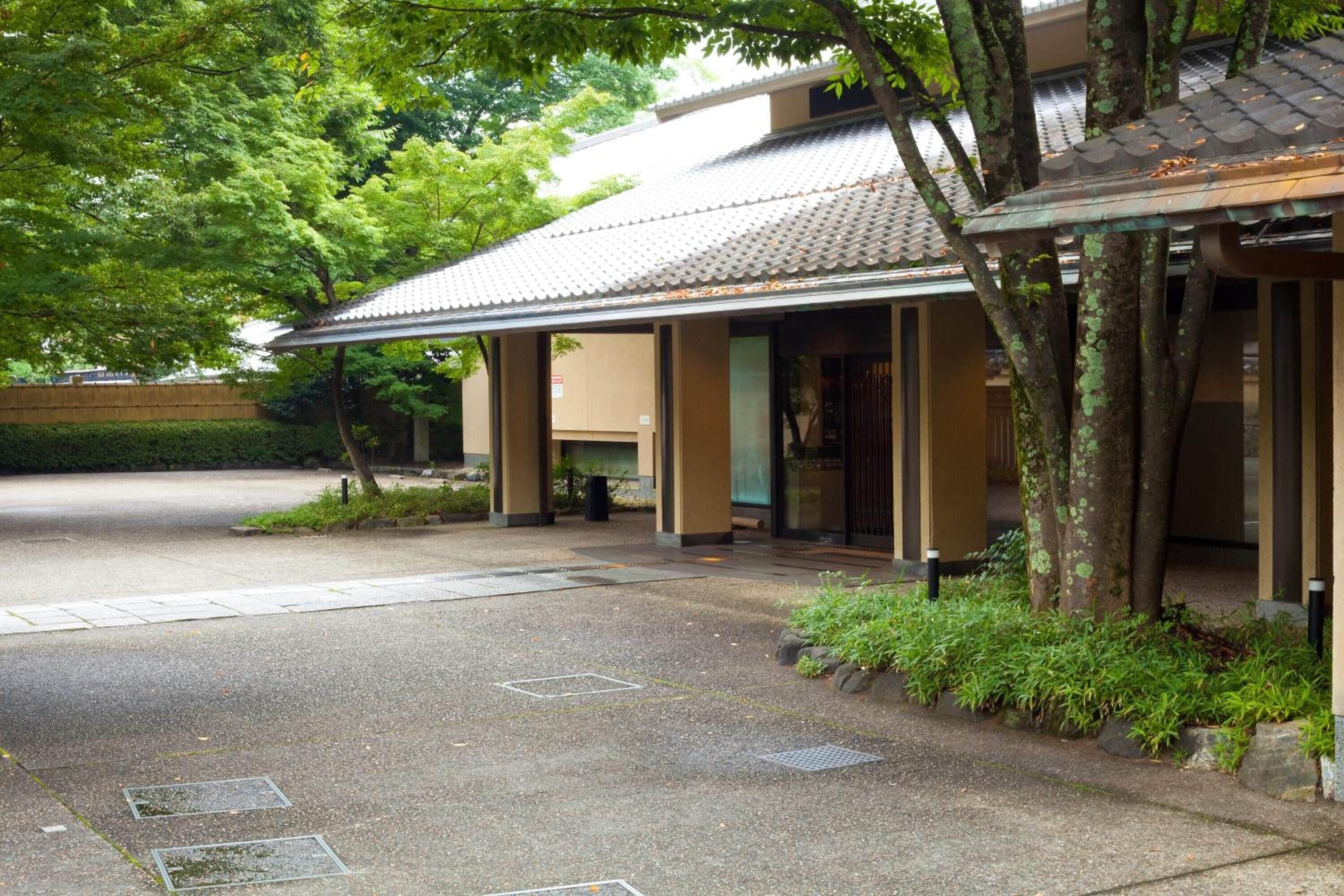 A traditional building with a tiled roof and a covered entrance area.