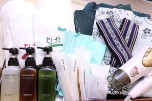 Toiletries including body soap, conditioner, and shampoo, along with a razor and hair dryer.