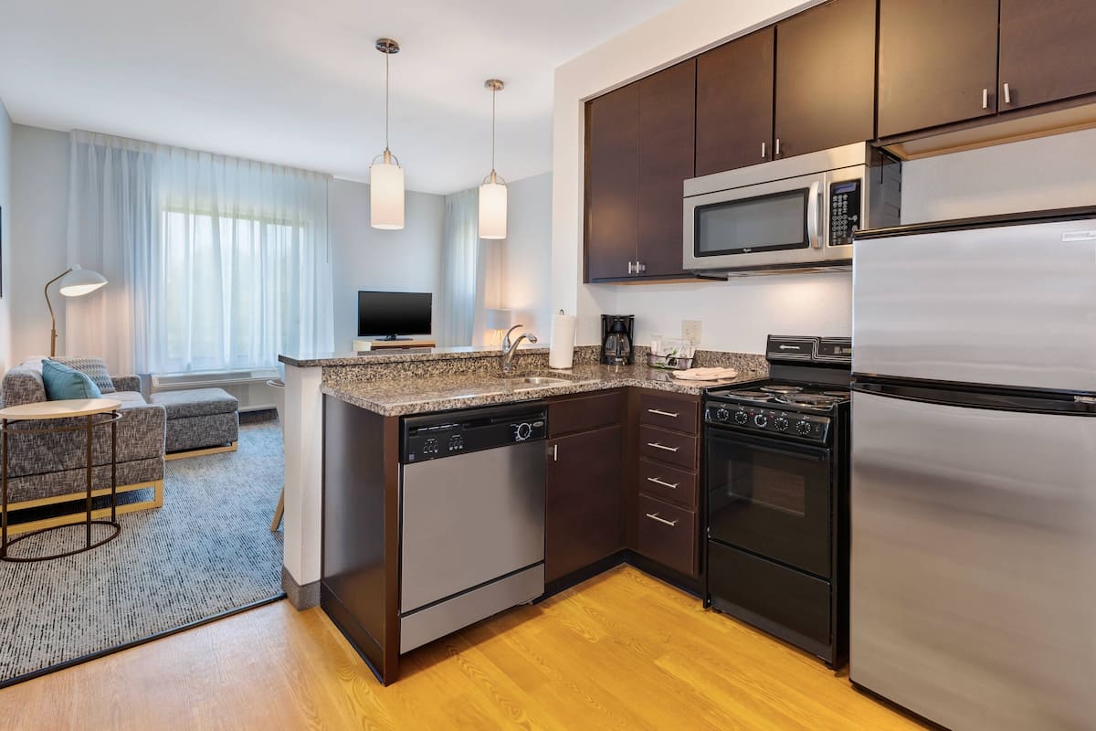 A modern kitchen with stainless steel appliances, a dishwasher, and a built-in oven.