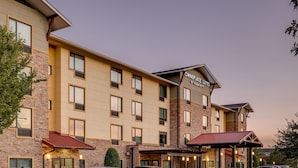 A multi-story hotel with a brick facade, multiple windows, and a sign indicating it is a Marriott hotel. - TownePlace Suites Monroe (Monroe)