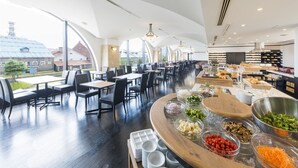 A modern restaurant with high ceilings, large windows, and a variety of seating options. - Hotel Nord Otaru (Otaru)