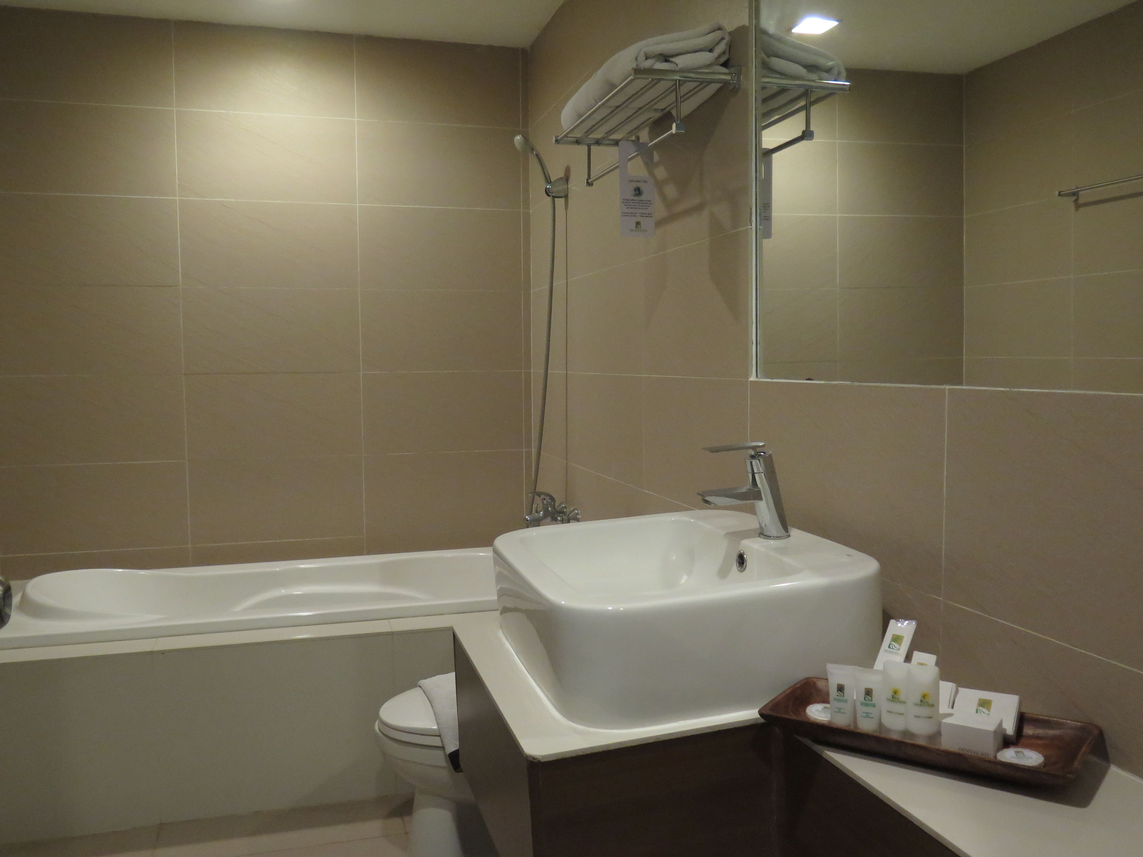 A modern bathroom with a bathtub, a sink, and a shower.