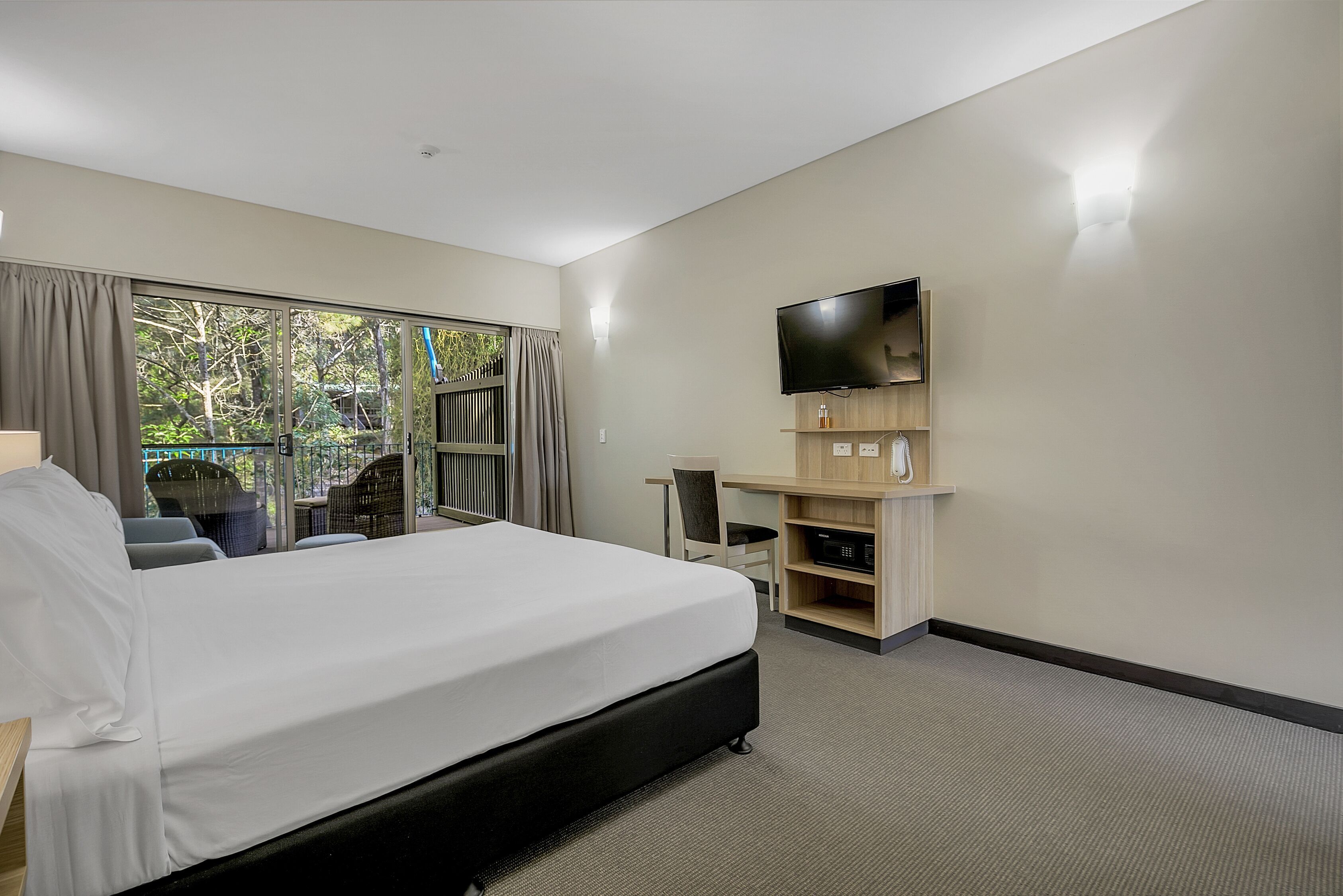 Laptop workspace, iron/ironing board, bed sheets