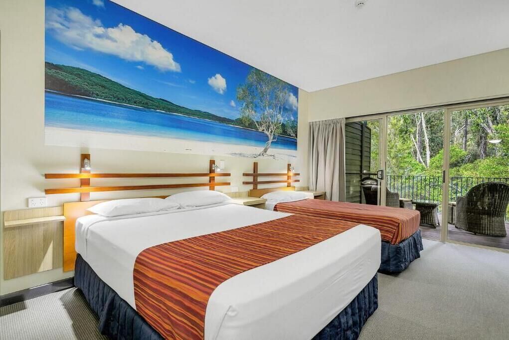 Wallum Family Resort Room | Laptop workspace, iron/ironing board, bed sheets