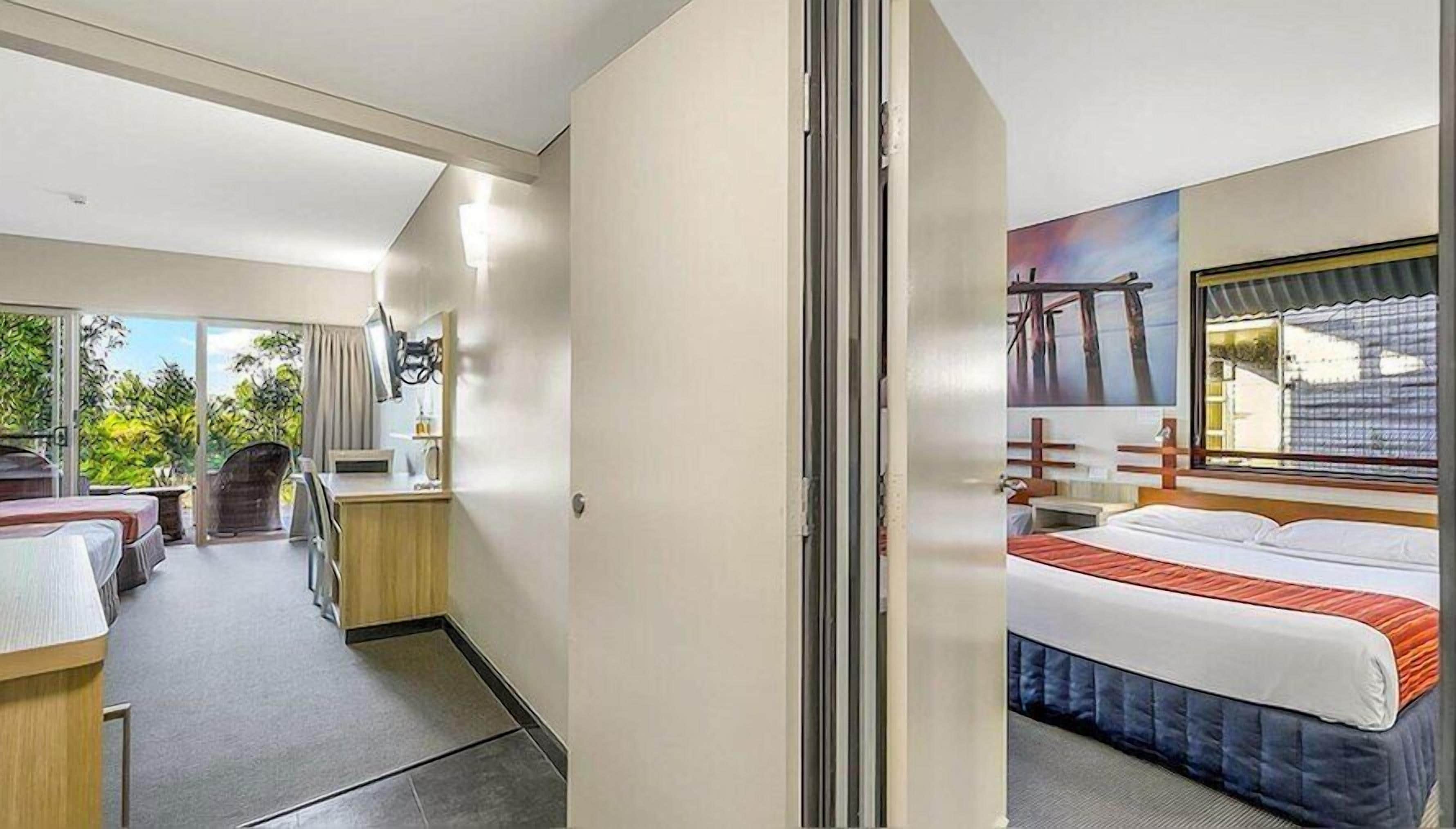 Laptop workspace, iron/ironing board, bed sheets