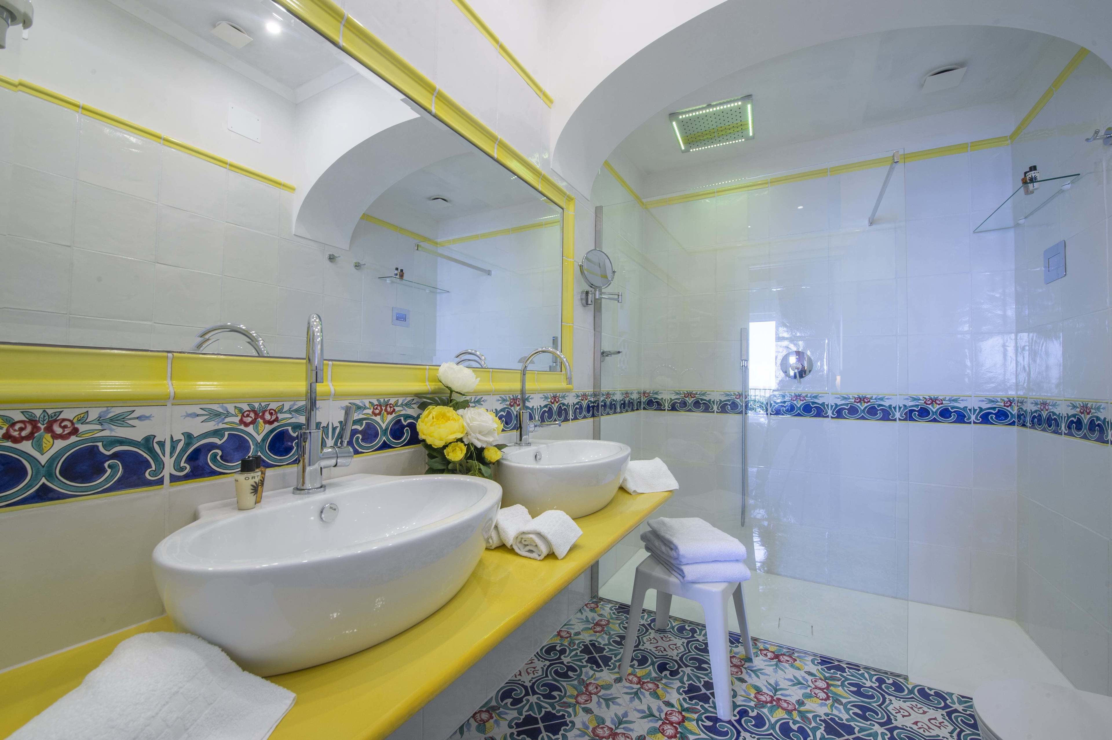 Un baño con dos lavamanos, un espejo y una ducha.