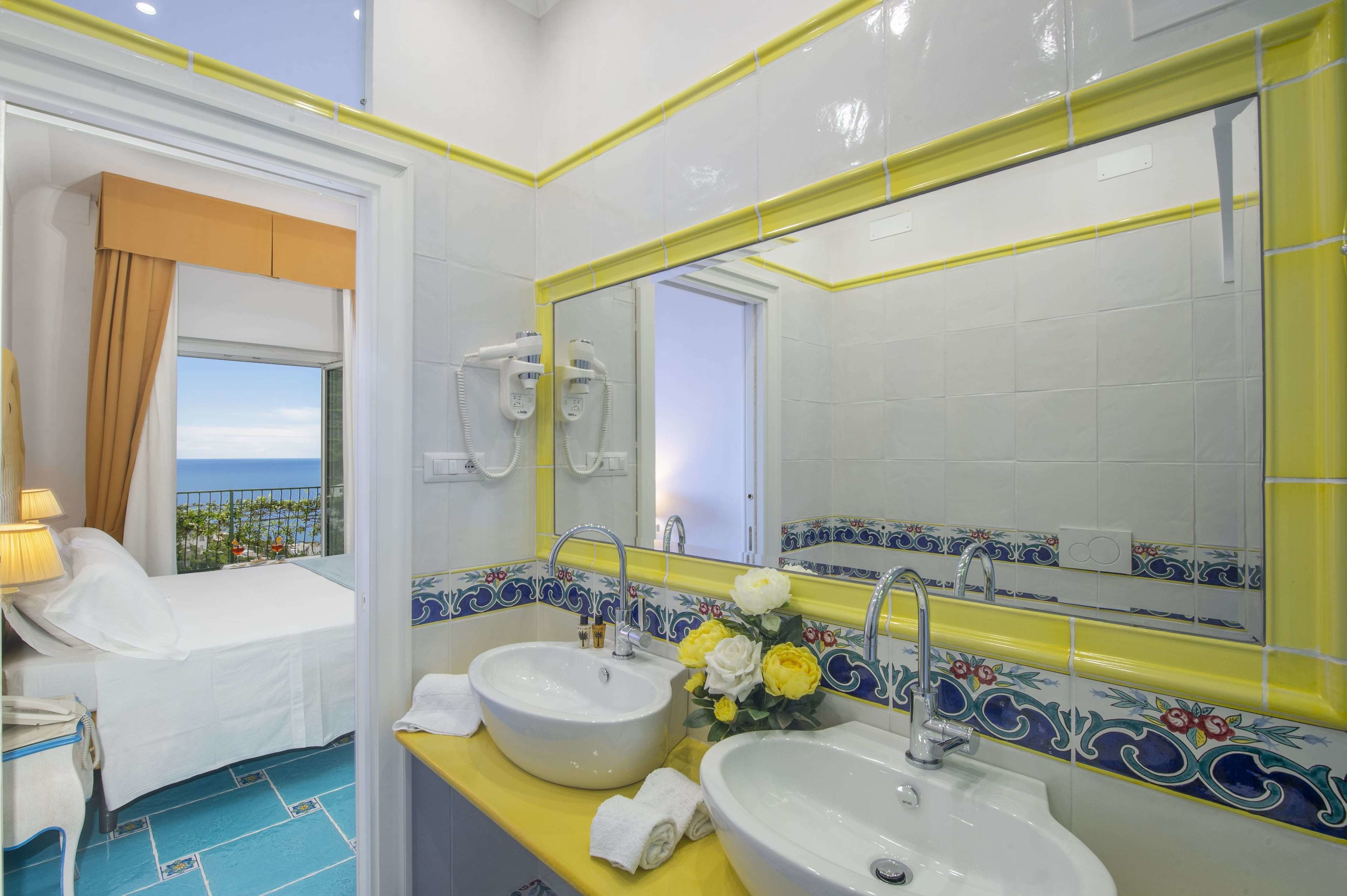 deluxe triple room | bathroom | rainfall showerhead, hair dryer, slippers, bidet