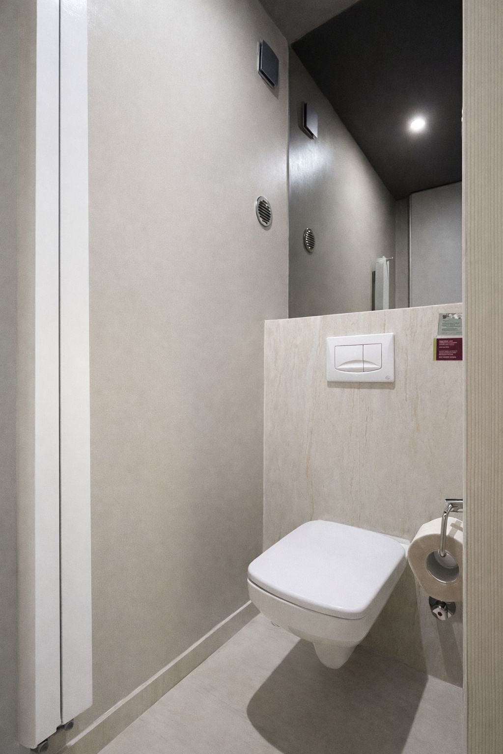 Une salle de bain avec des toilettes, un lavabo et un miroir.