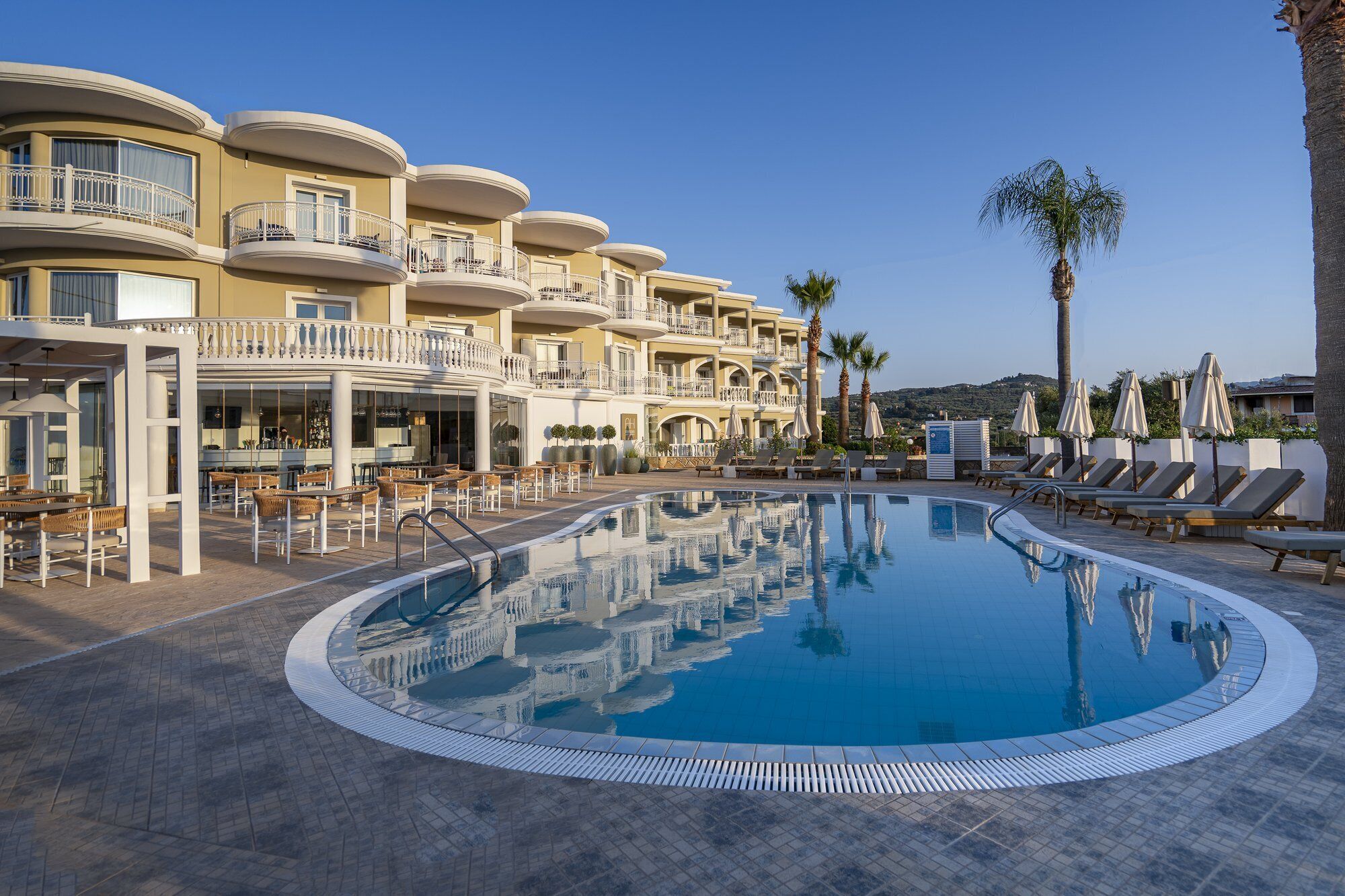 Alberca al aire libre, sombrillas en la alberca y camastros 